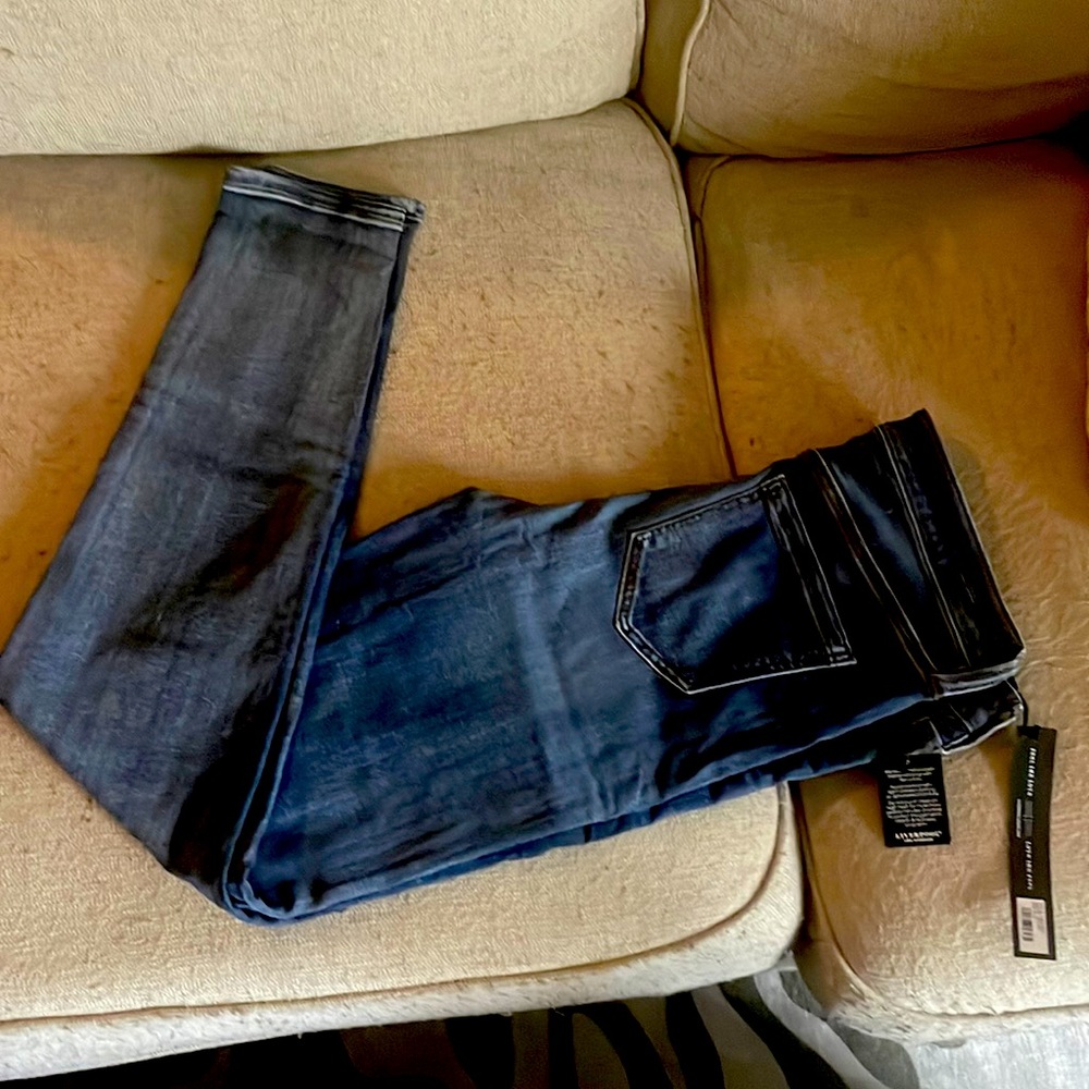 Dark wash skinny jeans. With tags